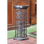 A cast iron bow fronted corner stick stand, beaded top, floral lattice work to front,