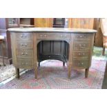 An Edwardian mahogany kidney shaped kneehole desk, moulded top above an arrangement of nine drawers,