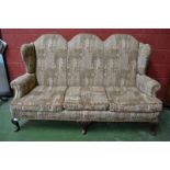 A George I design mahogany triple chair back sofa, stuffed over upholstery,