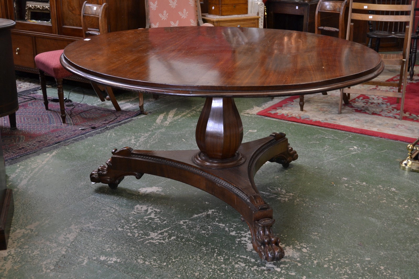 A William IV mahogany centre table, circular tilting top, panelled baluster column,