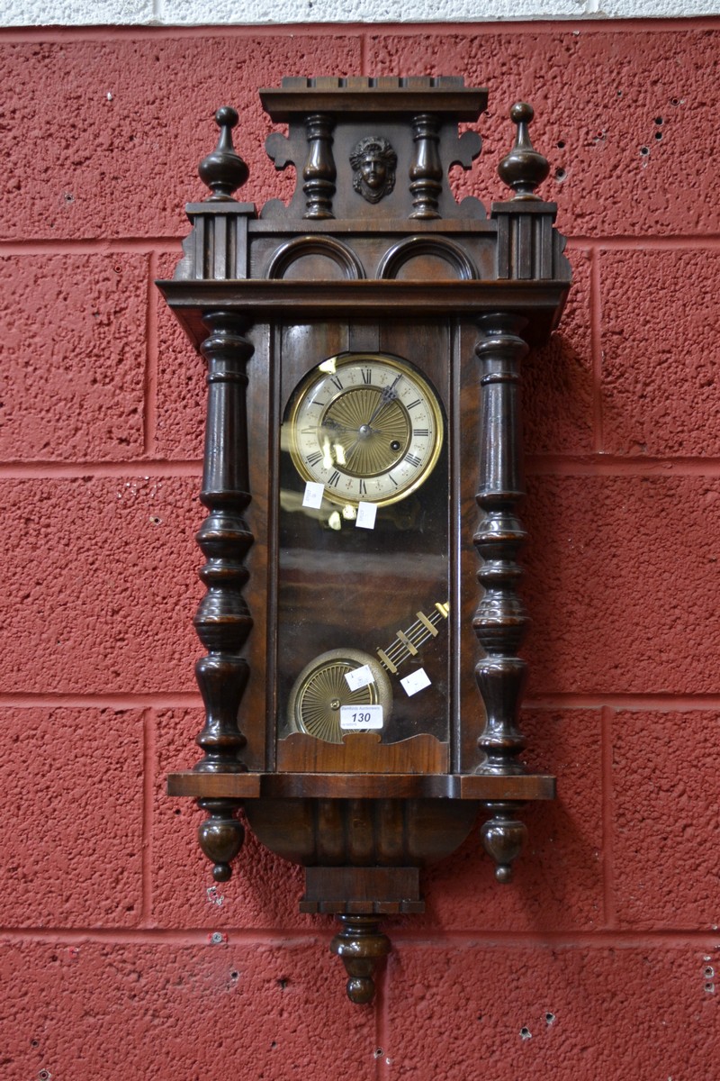 A mahogany Vienna wall clock, enamelled chapter ring, Roman numerals flanked by turned half columns.