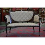 An Edwardian two seat sofa, shaped top rail, padded back, outswept curving arms, padded seat,