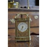 A French gilt brass shaped carriage timepiece,