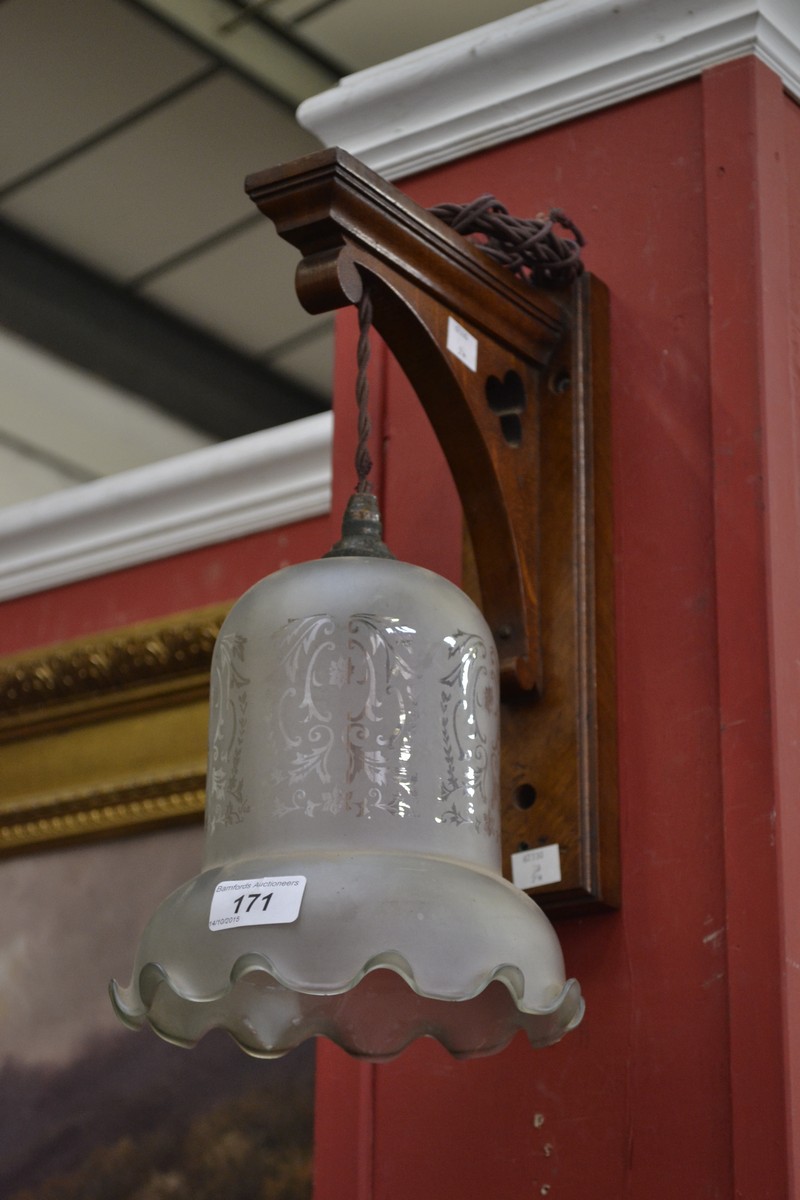 Gothic revival oak wall lamp with etched glass shade