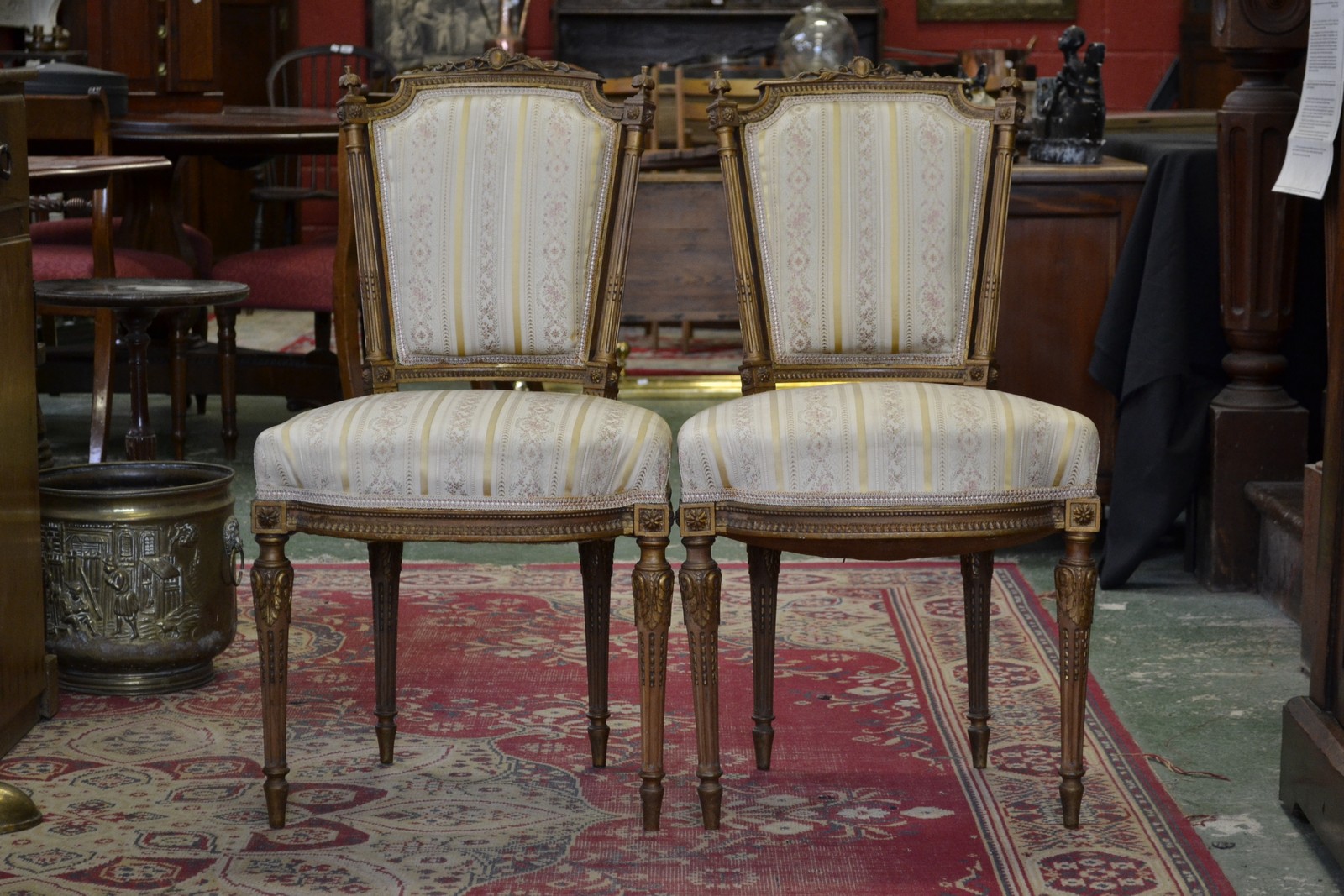 A pair of Louis XVI style giltwood side chairs, carved cresting rails, stop fluted uprights,