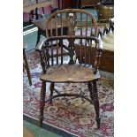 A 19th century elm and ash Windsor elbow chair, hooped back, shaped and pierced splat, saddle seat,
