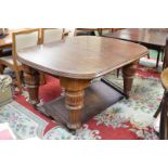 A large Victorian mahogany wind-out dining table, three leaves, bold fluted and turned legs,
