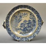 A 19th Century Staffordshire Willow warming dish, decorated in the willow pattern,