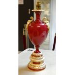 A Royal Worcester ruby ovoid  lamp, flying leafy scroll handles, the base with leaves and flutes,