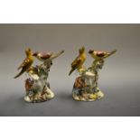 A pair of German groups, modelled with two oversize birds perched on blossoming branches,