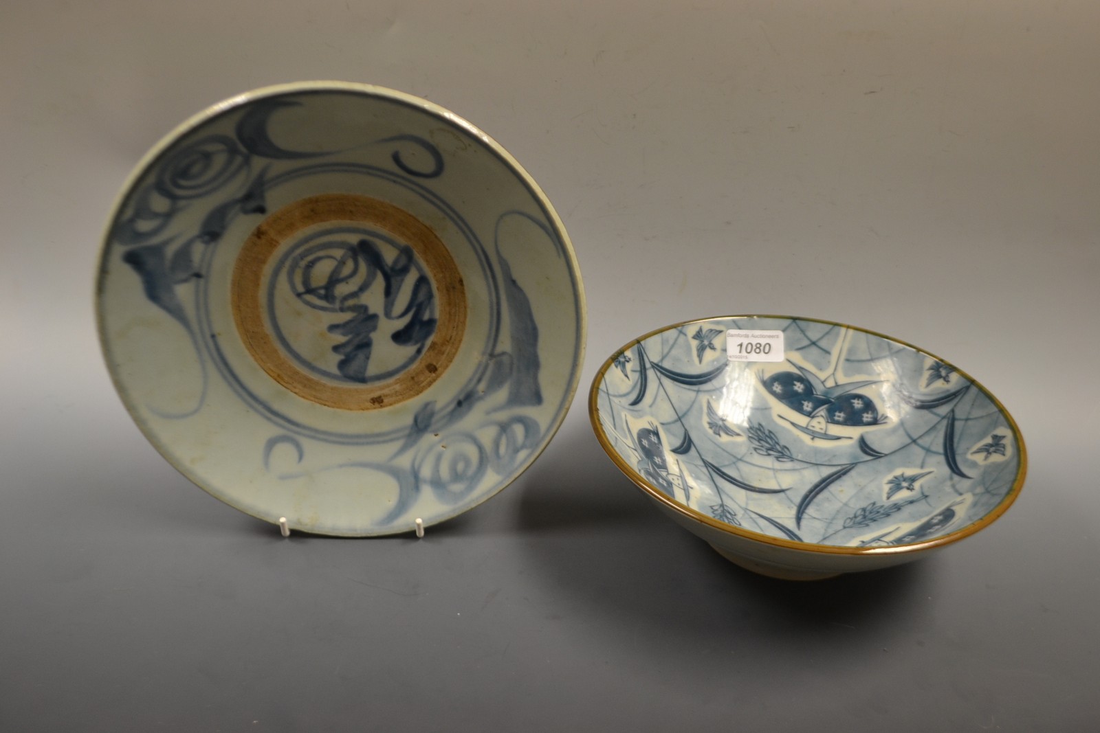 A Chinese blue and white shallow dish, the interior painted with scrolls in blue, unglazed band, - Image 2 of 2