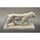 A Berlin KPM model of a ferocious lion, he stands with his mouth agape, glazed overall in white,