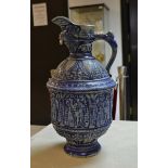 A large German stoneware Westerwald single handled ewer, moulded in relief with classical figures,