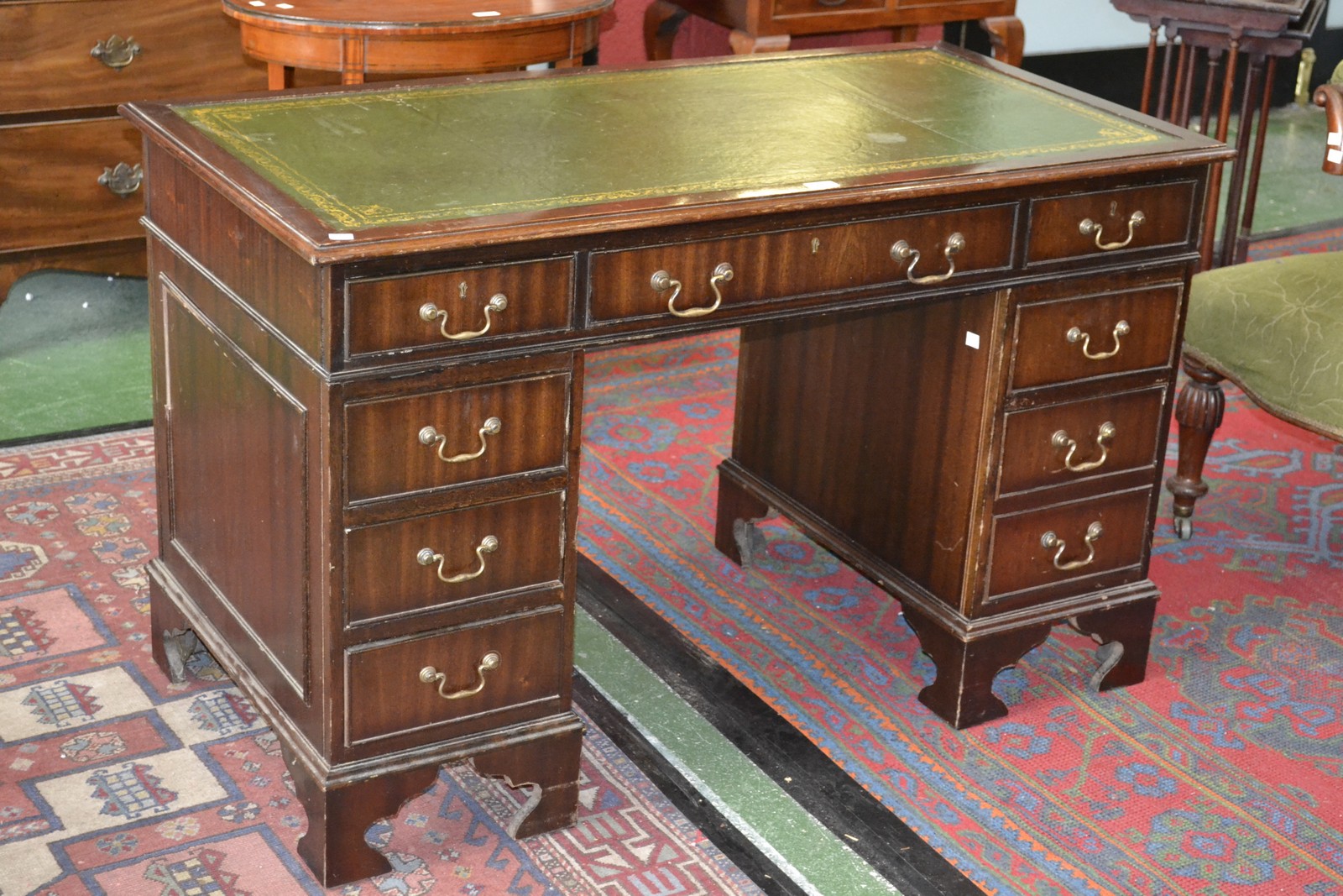 A mahogany pedestal desk with leather top