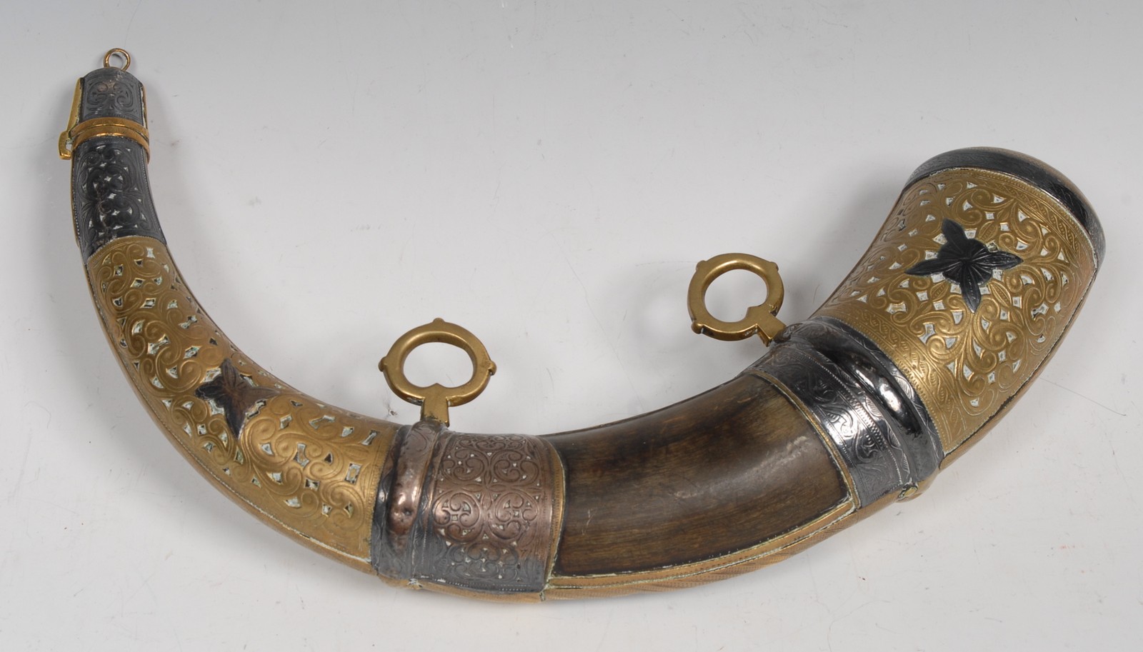 A large Persian silver and brass mounted cattle horn powder flask, bayonet-fitting cap,