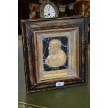 A Grand Tour style painted wood and composition portrait plaque,