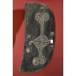 Tribal Art - a Papua New Guinea war shield, carved with lozenge and scroll motifs, 88cm high,