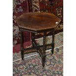 An early 20th century mahogany octagonal occasional table, fretwork x-frame stretcher, turned legs,