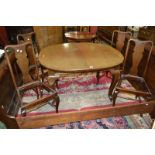 An early 20th century mahogany windout table, rounded top, cabriole supports,