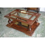 A mahogany coffee table, glass insert, architectural supports,