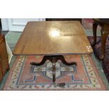 A Regency mahogany rounded rectangular breakfast table, tilting top with moulded edge,