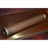 An early 20th century brass and leather three-draw telescope, The Marksman, by J H Steward Ltd,