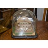 A Tyrolean softwood model, of a traditional Swiss cottage, glass dome, ebonised base,