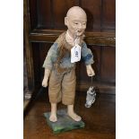 A Chinese composition figure, of a fisherman, he stands, holding his catch, 36cm high,