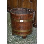 An Arts and Crafts brass bound oak coopered log bin, axehead handles, 36.5cm diam,  38cm high,c.