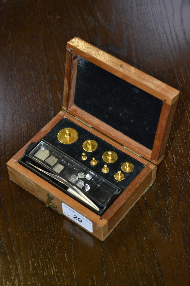 A mahogany cased set of jeweler's weights