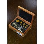 A mahogany cased set of jeweler's weights