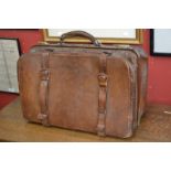 A 19th century leather Gladstone bag, the interior with silver  dressing case jars,