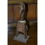 Tribal Art - an African figural heddle pulley, probably Baule, carved with a mask, 23cm high,