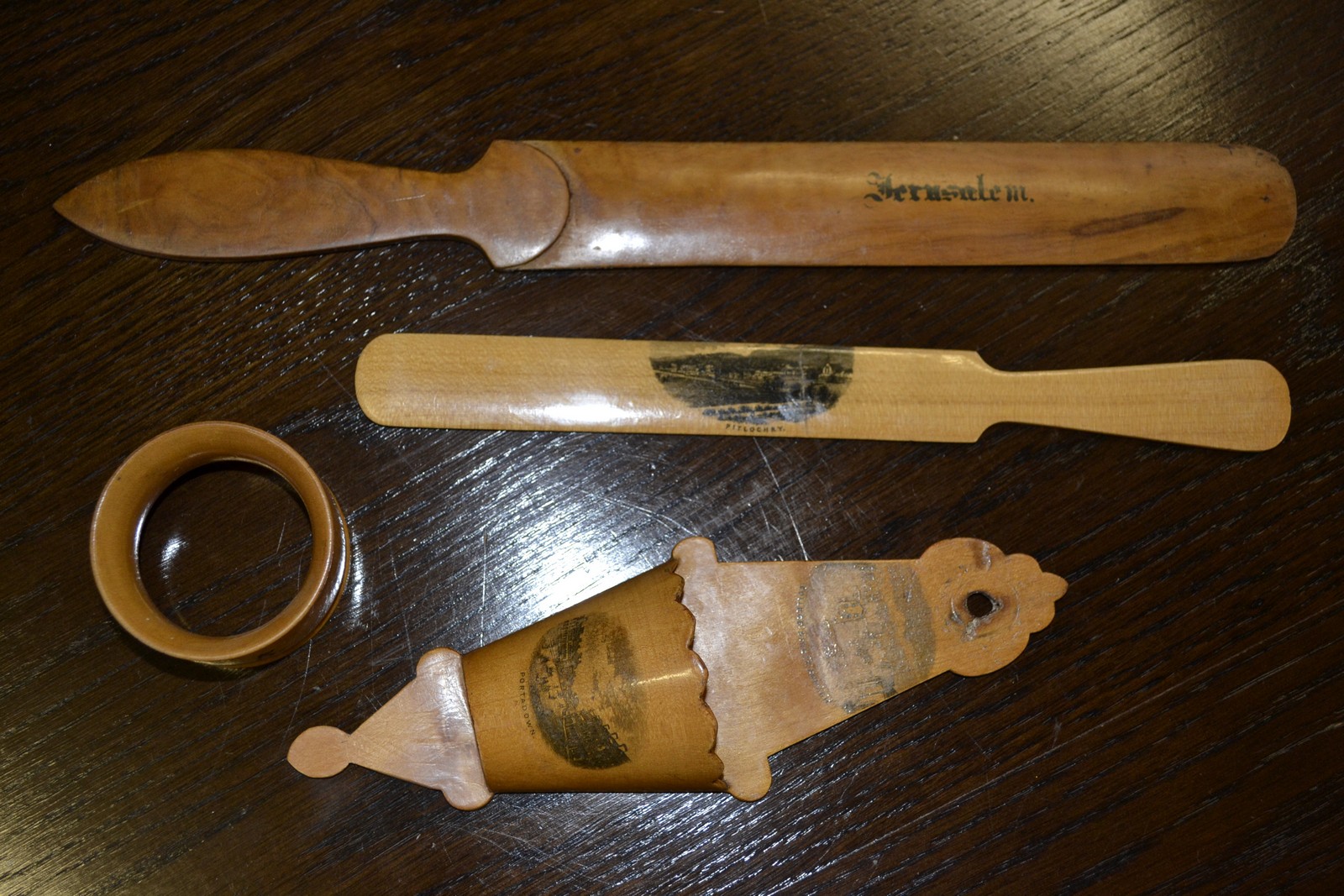 Two mauchline ware treen page turners; a wall pocket;