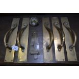 A set of five Edwardian brass plate door handles, S-scrolls handle, rectangular back plate,