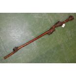 A 19th century folk art rootwood walking cane, the pommel carved as a grotesque face,