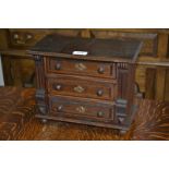 An early 20th century oak miniature chest of drawers