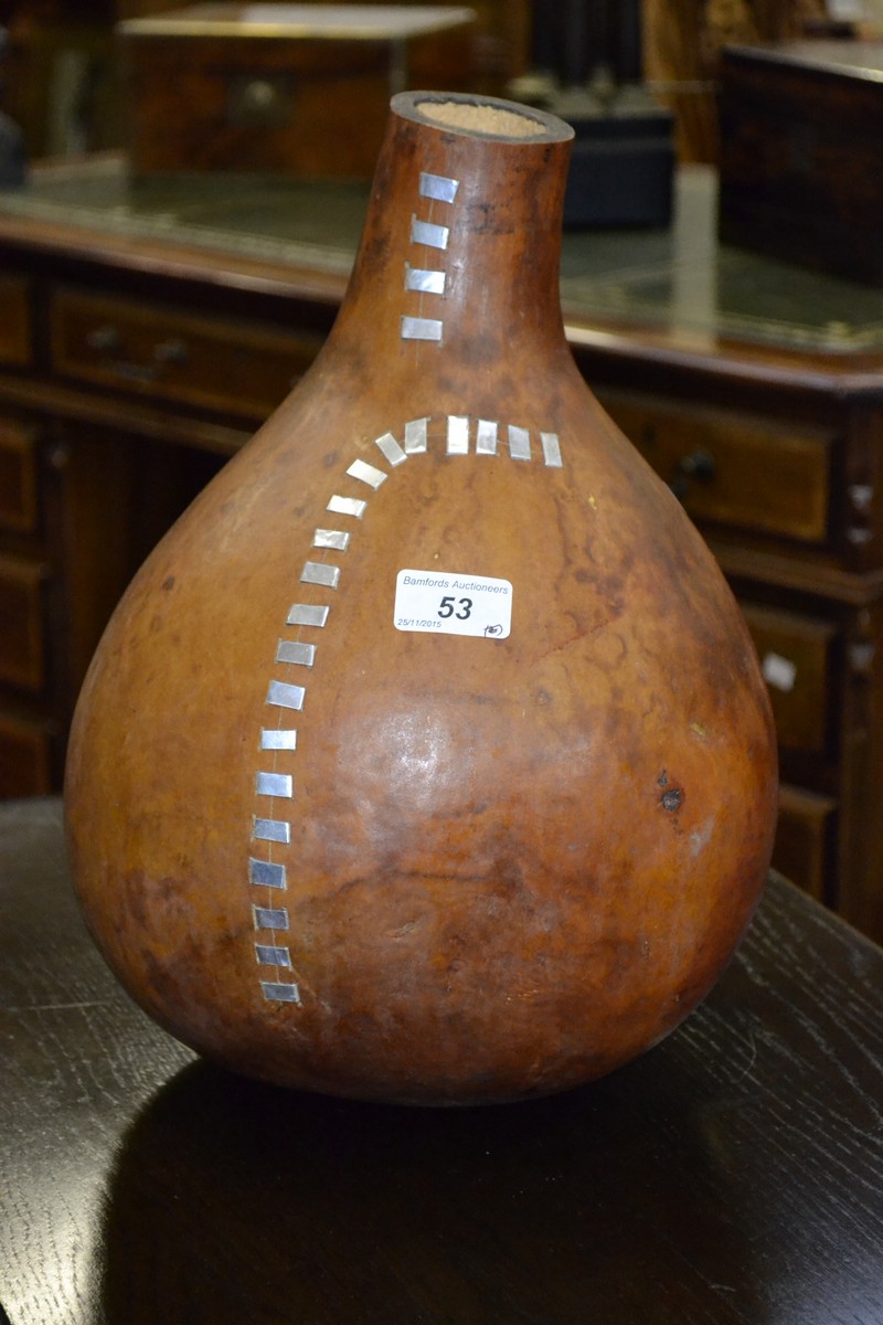 Tribal art - A large gourd inset with metal strips.