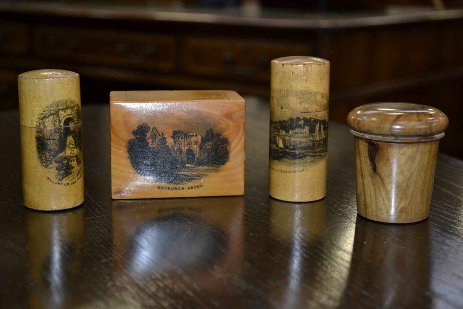 A 19th century treen money box; two cylindrical boxes; a cased glasses engraved table, dessert,