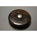 An early 19th century lignum vitae waisted circular snuff box,