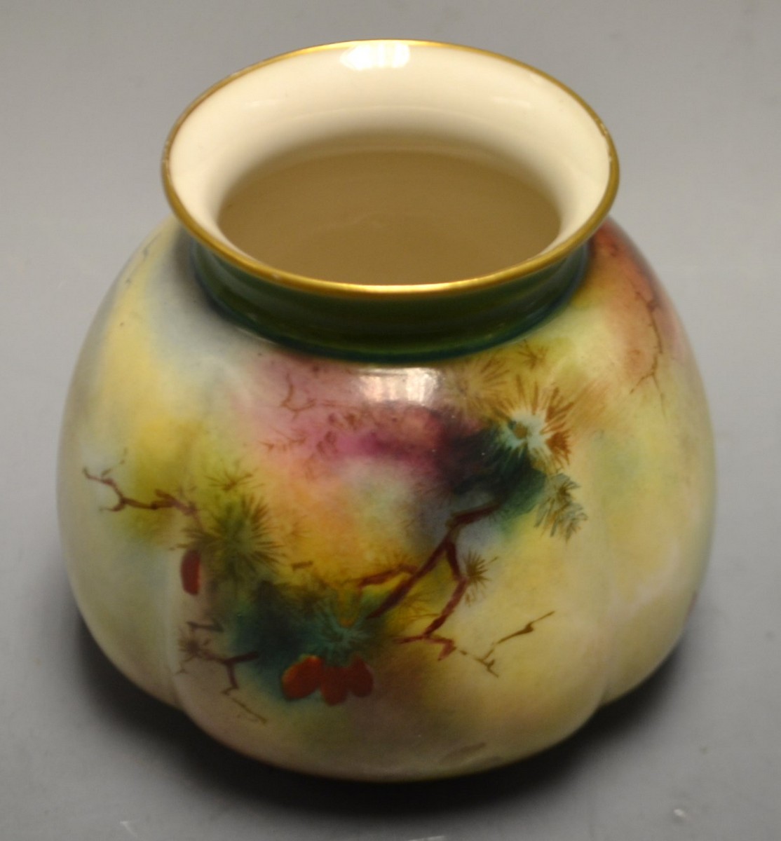 A Royal Worcester lobed vase, painted with peacocks in a stylized landscape, green printed marks,