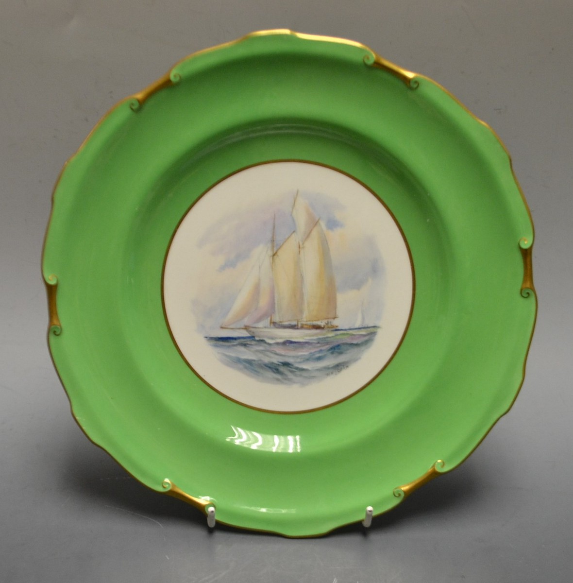 A Royal Crown Derby shaped circular plate, painted by W E J Dean, signed, Golden Hind,