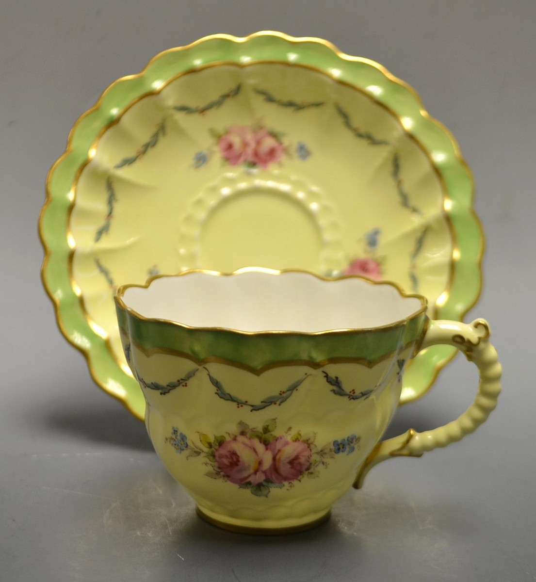 A Victorian Royal Crown Derby cup and saucer, pattern 5226, painted with pink flowers,