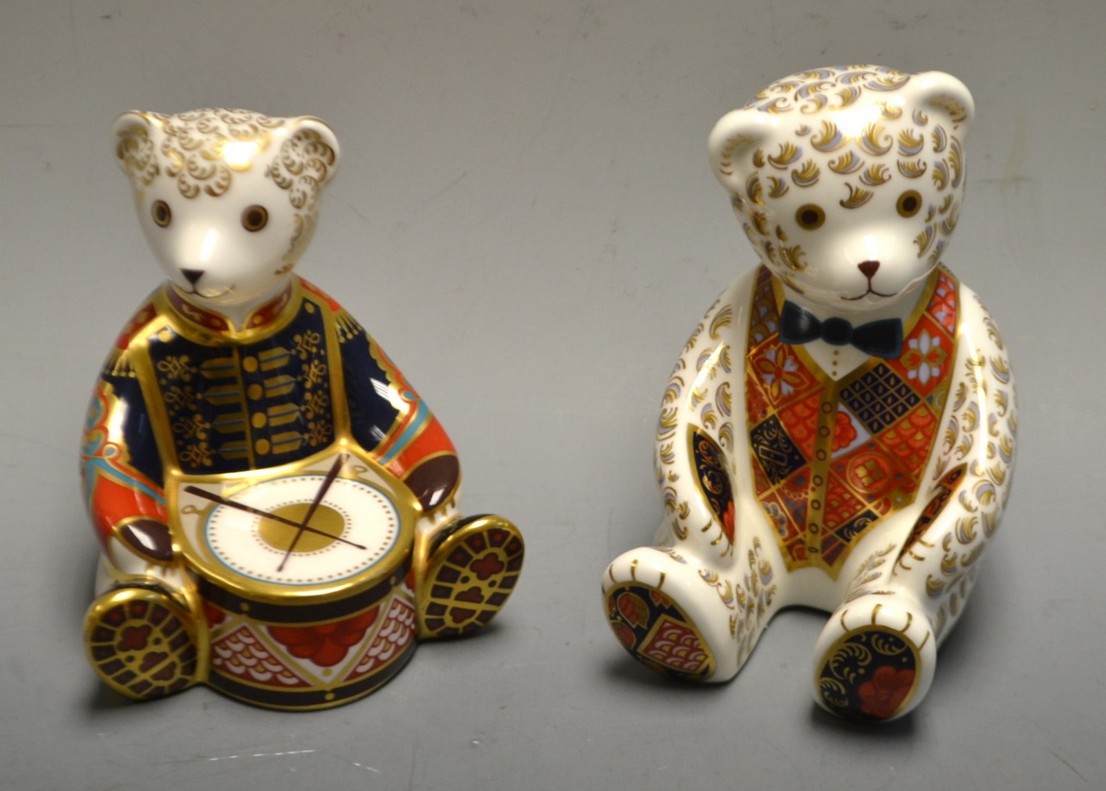 A Royal Crown Derby paperweight Drummer Teddy; another, silver stoppers,