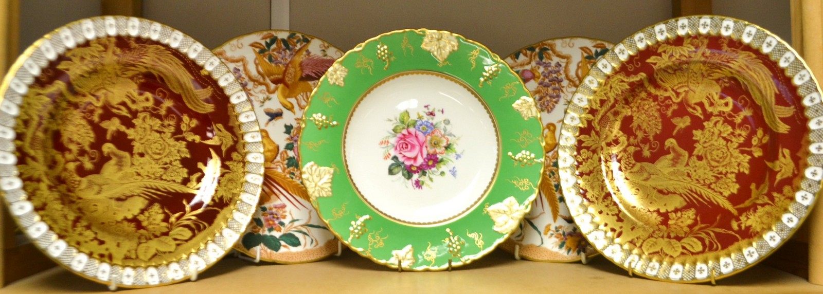 A pair of Royal Crown Derby Red Aves dinner plates, heraldic borders,