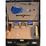 A Walker and Hall silver plated and blue guilloche enamel travelling vanity set,