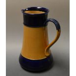 An early 20th century Royal Doulton earthenware water jug, plain and blue banded body,
