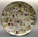 A longwy pottery charger, transfer printed with and painted with a Village Fair,