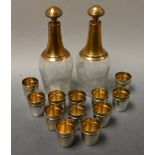 A pair of French gilt metal mounted scent bottles, etched with ferns, six gilt metal shot glasses,