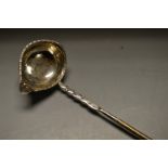 A George III silver coloured metal toddy ladle, boat shaped bowl with gadrooned border,